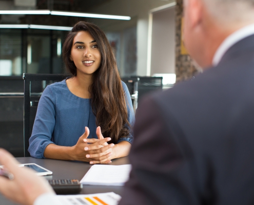 Smiling female client talking to male manager